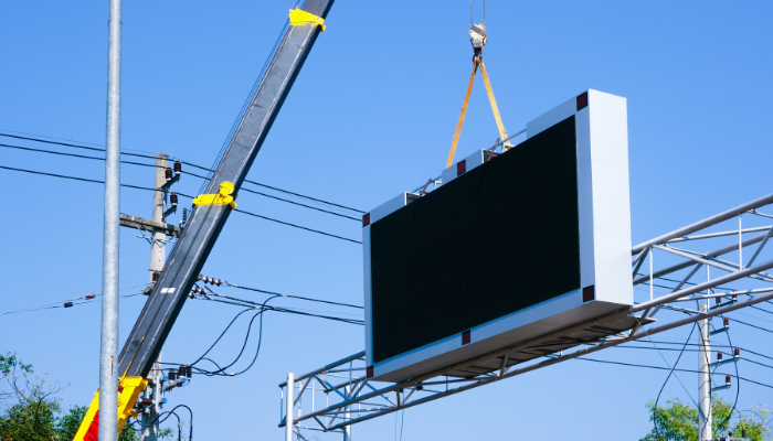 Outdoor LED screen being installed using a crane – suitable for large-scale advertising and public display.