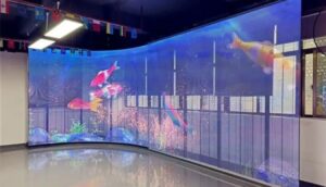 A large interactive LED screen displaying vibrant content, being controlled via touch and gestures in a modern commercial setting.