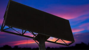 A large interactive LED screen displaying vibrant visuals, with a person using touch and gesture controls to interact with the content.